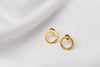 A pair of matte gold stud earrings with a butterfly back design, displayed against a white fabric background.