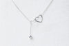 A sterling silver necklace with a double layer design featuring heart-shaped pendants.