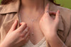 A sterling silver necklace with a double layer design featuring heart-shaped pendants.