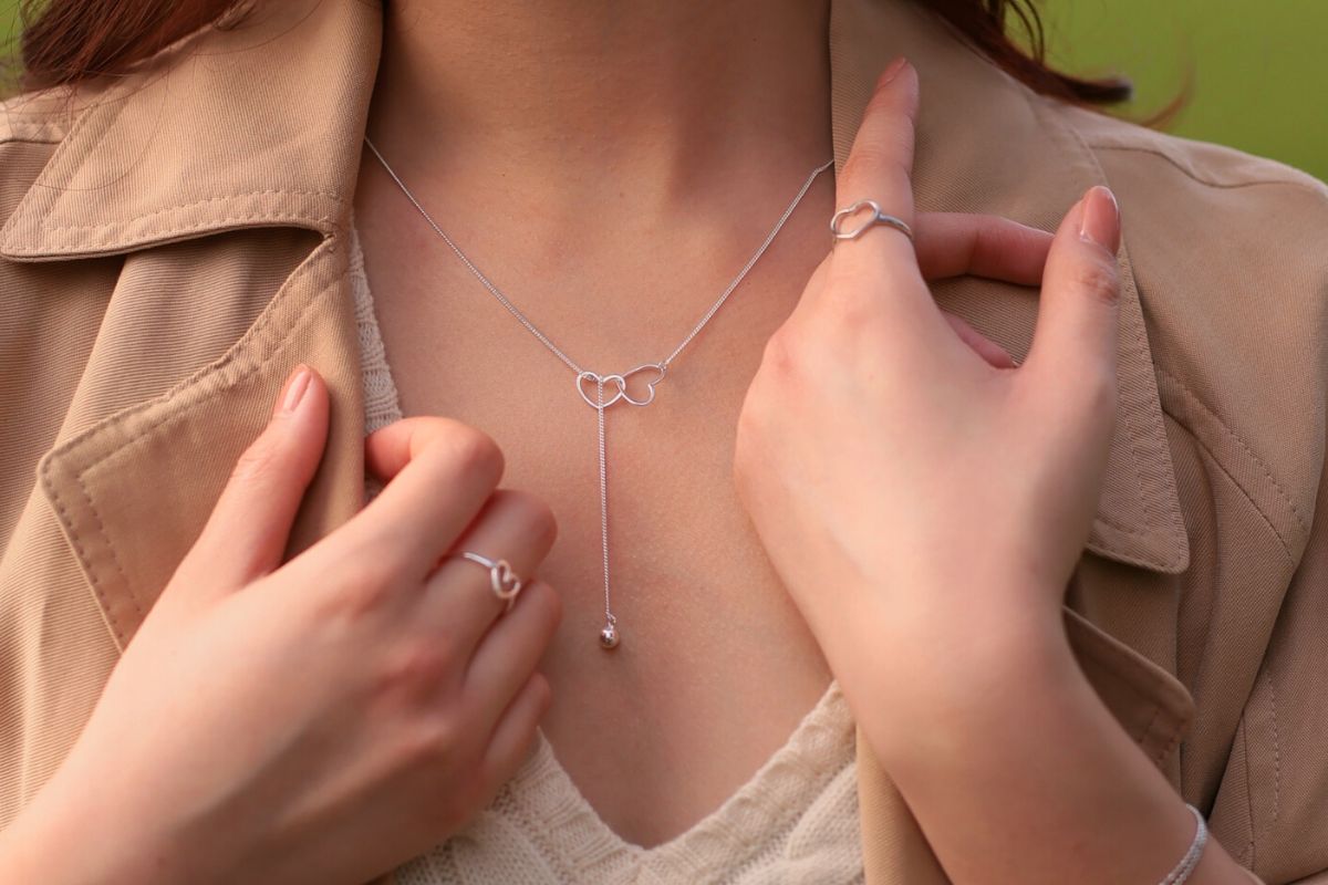 A sterling silver necklace with a double layer design featuring heart-shaped pendants.