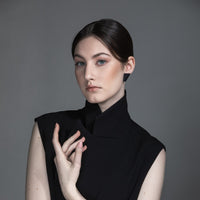 model wearing minimalist desgn matt black earring