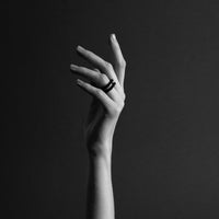 Close up of a hand wearing a black 3d printed ring