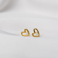 A pair of heart-shaped stud earrings made of sterling silver with gold vermeil coating, displayed on a white background.