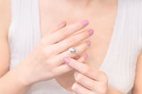Close up of a womans hand wearing a silver ball shaped ring