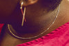 A sterling silver necklace with a series of round beads, worn by a woman
