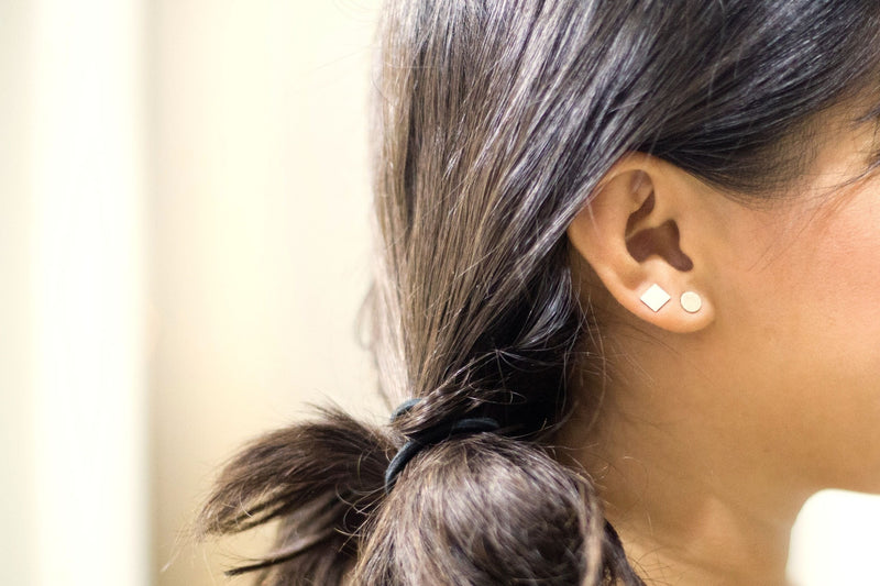 Earlobe wearing square sterling silver stud